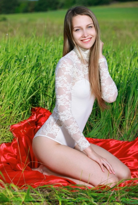 Pretty teen Violet doffs a lace onesie to model naked in a field 54567016
