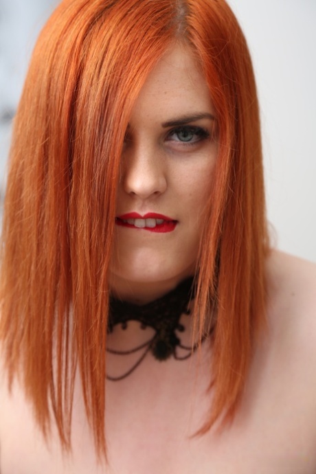 Chubby redhead Alexsis Faye uncups her huge tits in black stockings 77005314