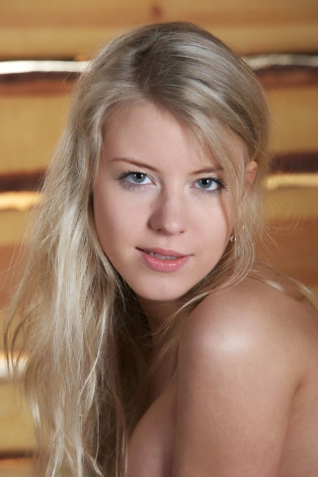 Young blonde girl shows off her big tits and pussy atop a bale of hay 89567571
