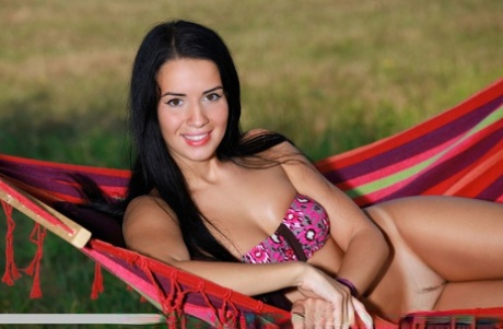 Dark haired teen Lola Marron shows off her tan lined body outside on a hammock 35807891