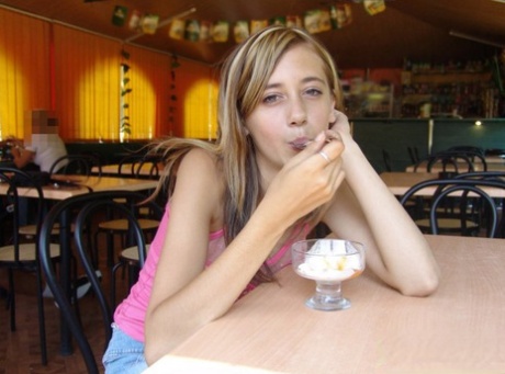 Teen amateur enjoys a dessert at a restaurant in a short denim skirt 64326042