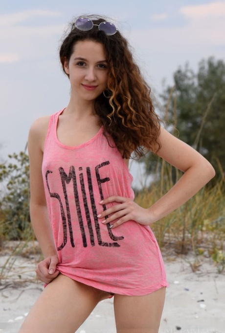 Nice teen Melissa Maz sports wavy hair while getting naked on sandy ground 70563640