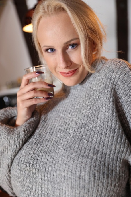 Blonde amateur Angel Wicky frees big tits from sweater as she strips to socks 49222693
