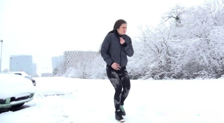 Lara Fox takes an urgent piss on snow-covered ground near parked cars 48490802