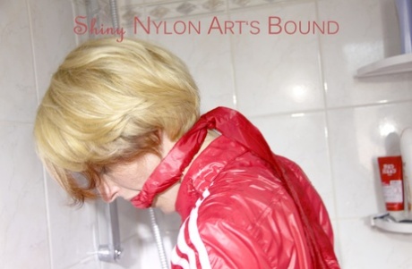Blonde chick is left handcuffed to a bathtub tap in a nylon jumpsuit 29889620