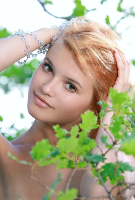 Adorable redhead Violla A displays her naked teen body atop a rock outdoors 57204667