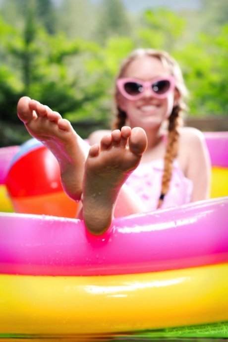 Adorable teen Dolly Little tugs on her braided pigtails in a blowup pool 59875167