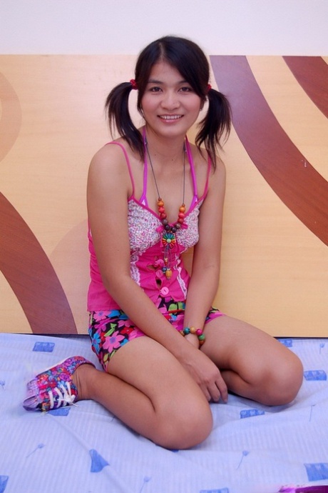 Asian teen gets naked in shoes with her hair set into pigtails 69653641
