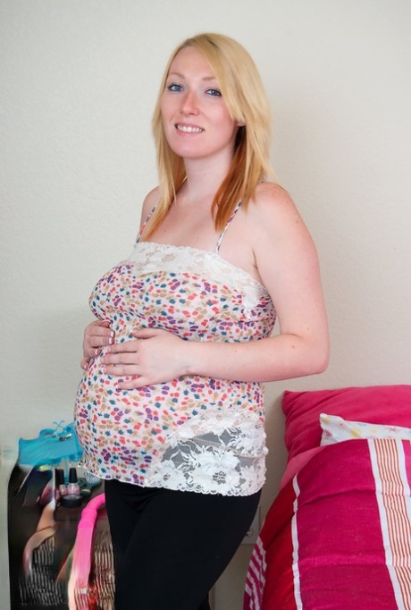 Pregnant blonde picks up a pink sex toy after getting completely naked 48730909