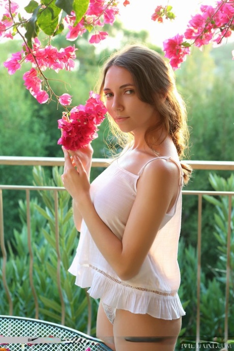 Busty teen Danniela gets completely naked on a balcony during solo action 67992962