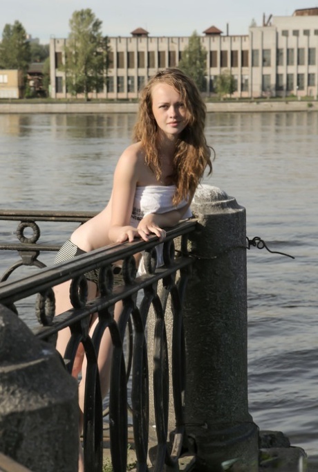 Barely legal girl Vega gets naked on a railing in a public place 84307922