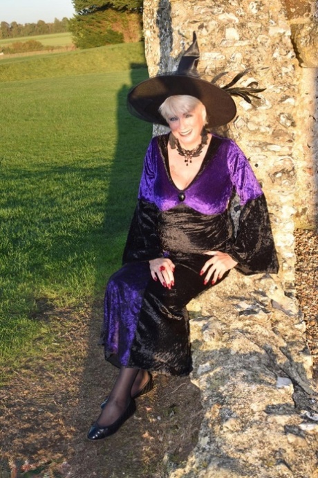 Older blonde witch Dimonty poses outdoors in her lingerie and nylons 64471730