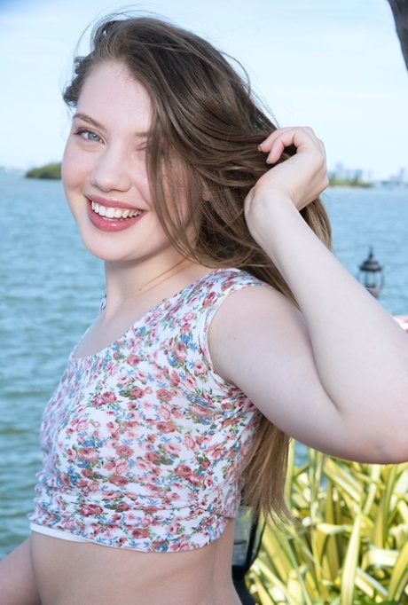 Sweet teen Elena Koshka uncovers her tiny breasts while fishing from shore 17407832