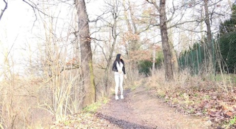 Brunette chick Maddi Black pulls down her jeans to pee on a path in the woods 42711152