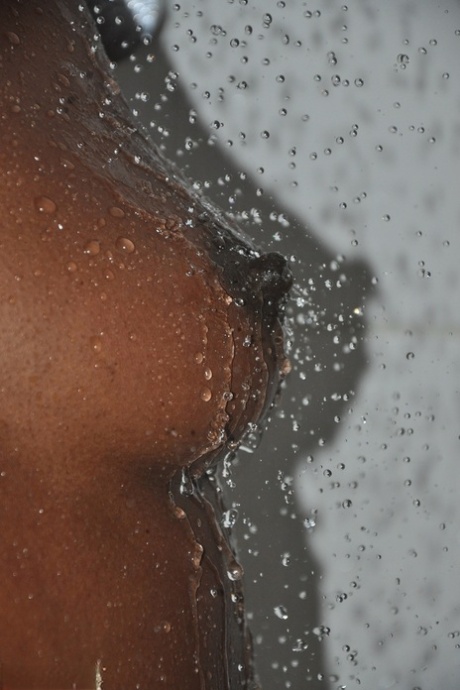 Black girl with short hair shows her firm tits and booty under running water 57069998