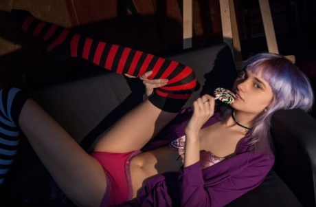 Teen solo girl with dyed hair and piercings bares her tits while licking candy 12882170