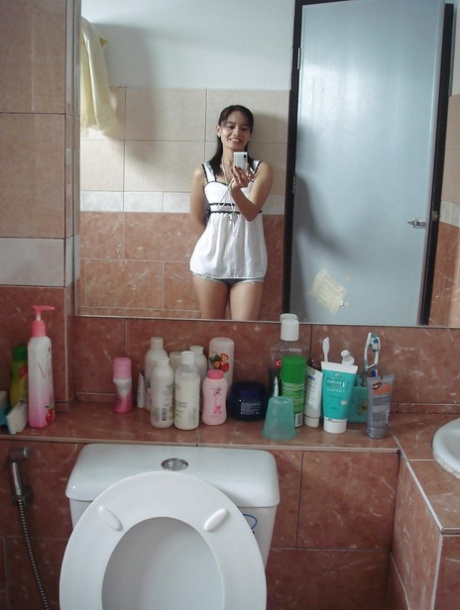 Petite Thai girl tales self shots before stripping naked in bathroom 35463515
