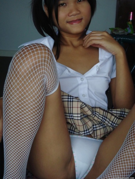 Asian cutie in mini skirt and stockings stripping and playing with a dildo 22965140